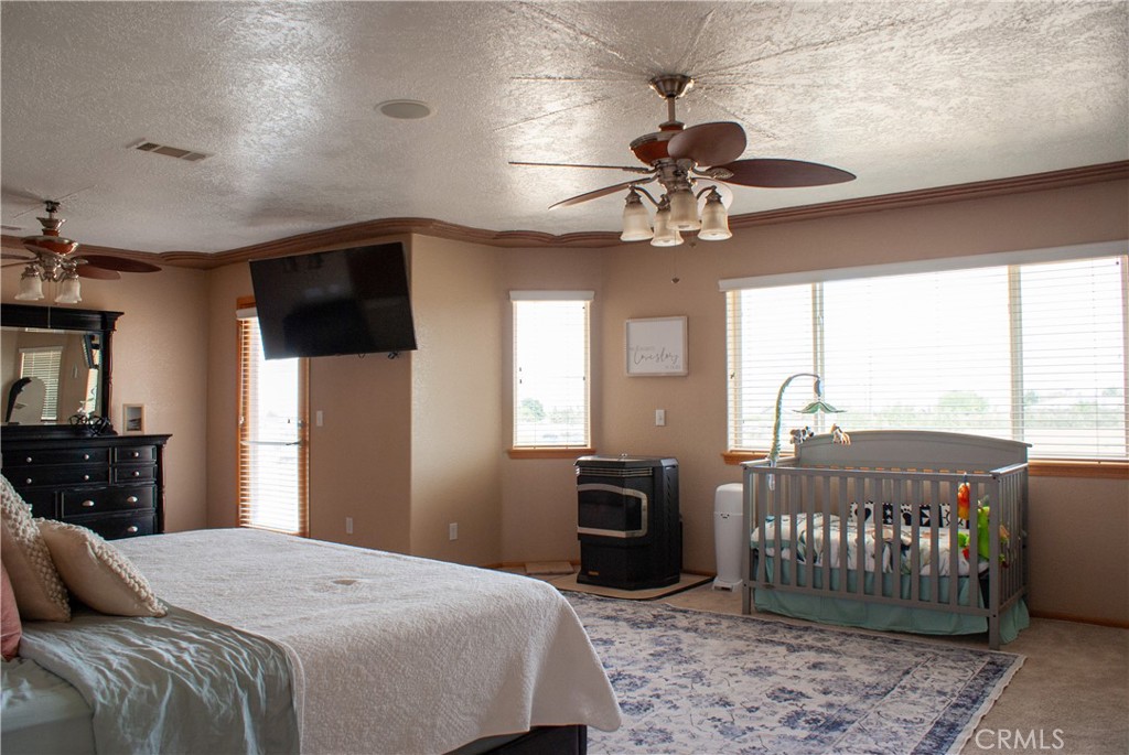 8465 Cedar Court Phelan, CA 92371 - Photo 45 of 51 a bedroom with a bed and a chandelier