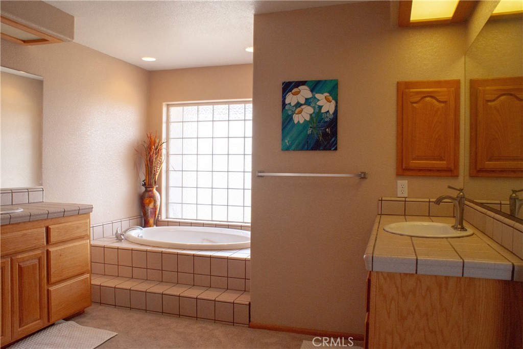 8465 Cedar Court Phelan, CA 92371 - Photo 46 of 51 a bathroom with a tub sink and mirror