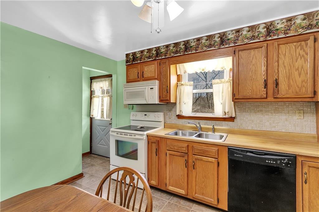 523 Allendale Road Rochester, PA 15074 - Photo 14 of 34 a kitchen with a sink stove and cabinets