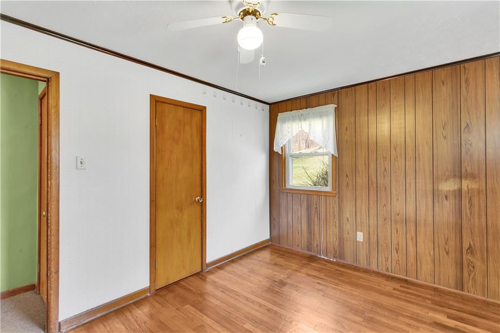 523 Allendale Road Rochester, PA 15074 - Photo 21 of 34 a view of an empty room with wooden floor and a window