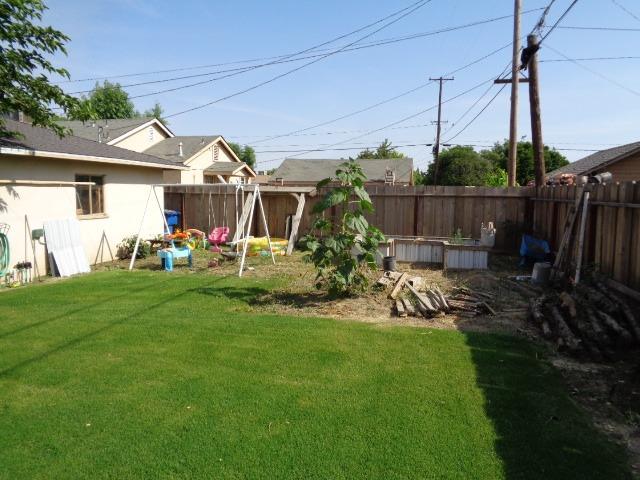 1061 Cyrier Avenue Reedley, CA 93654 - Photo 13 of 13 a view of a backyard with plants and a patio