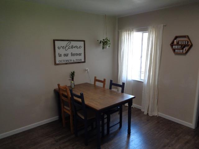 1061 Cyrier Avenue Reedley, CA 93654 - Photo 5 of 13 a view of a dining room with furniture and wooden floor
