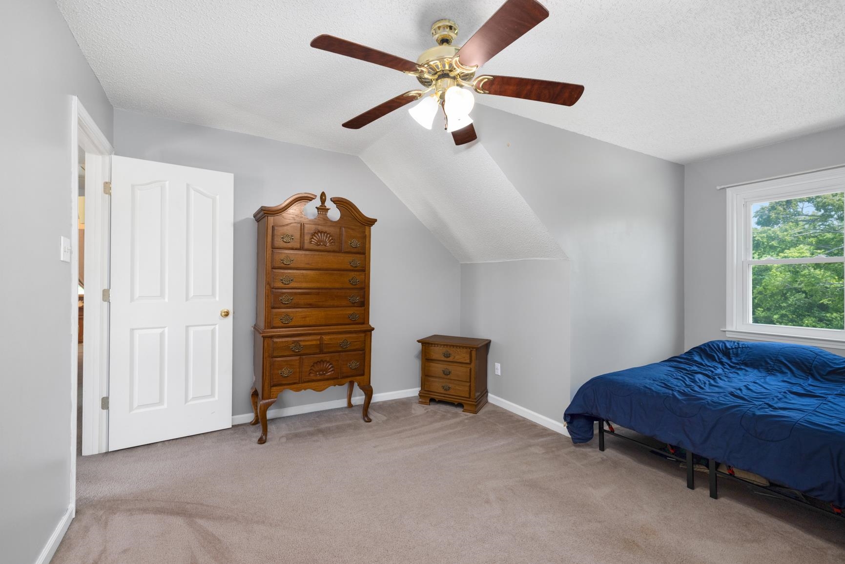 8539 Campground Road Drummonds, TN 38023 - Photo 32 of 38 a bedroom with a bed and a chandelier