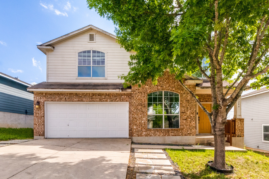 9204 Magna Carta Loop Austin, TX 78754 - Photo 1 of 27 Traditional-style home featuring driveway, a garage, and brick siding