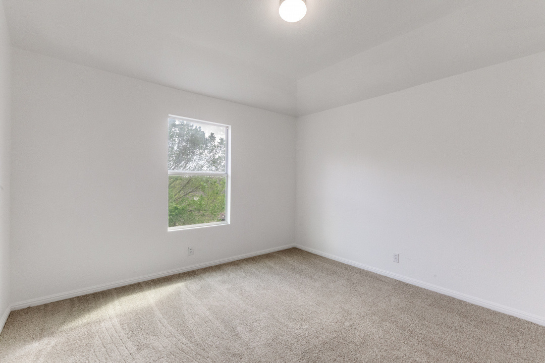 9204 Magna Carta Loop Austin, TX 78754 - Photo 22 of 27 Empty room featuring light colored carpet and baseboards
