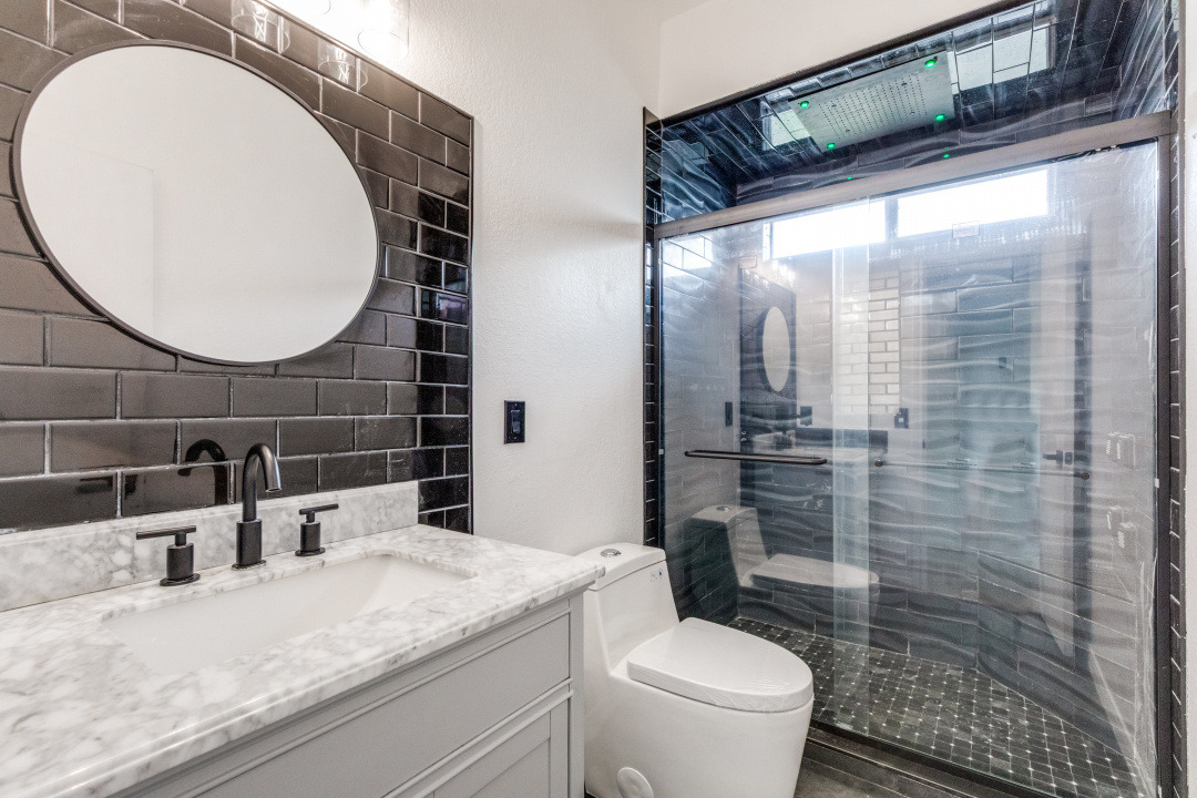 9204 Magna Carta Loop Austin, TX 78754 - Photo 23 of 27 Bathroom with vanity, a stall shower, and backsplash