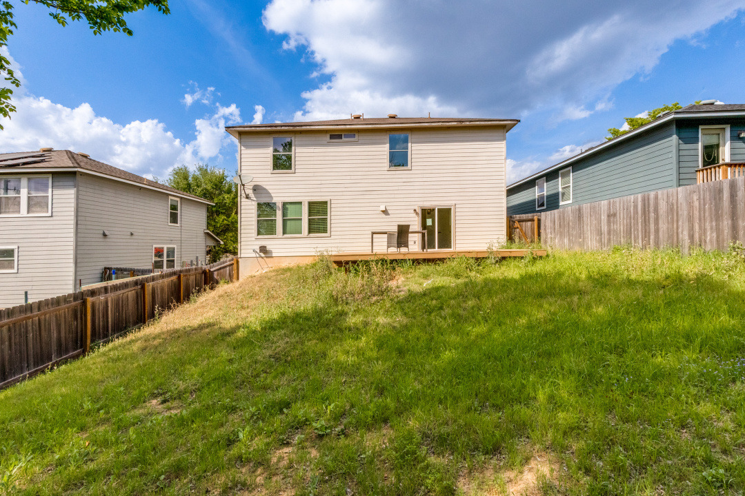 9204 Magna Carta Loop Austin, TX 78754 - Photo 25 of 27 Back of house with a fenced backyard and a patio
