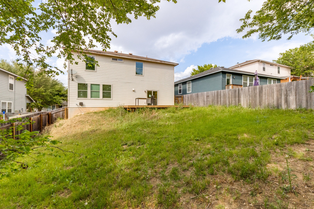 9204 Magna Carta Loop Austin, TX 78754 - Photo 26 of 27 Back of house featuring a fenced backyard