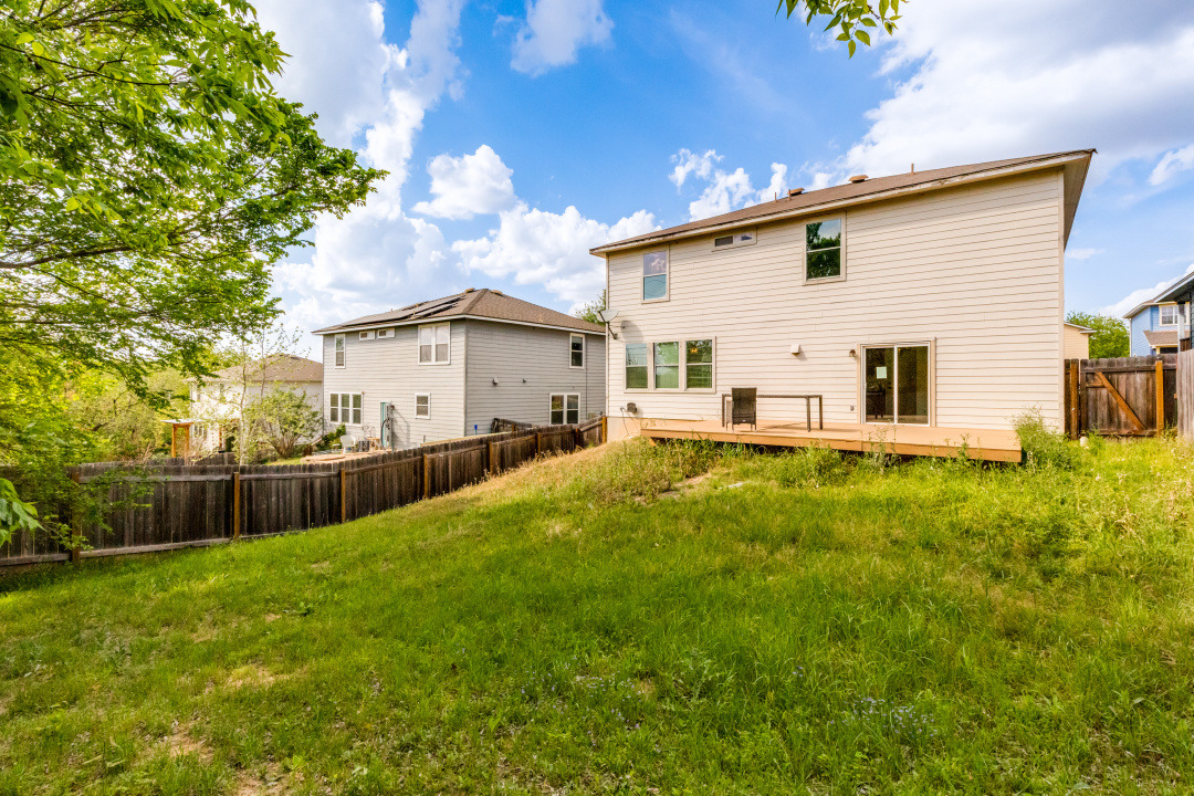 9204 Magna Carta Loop Austin, TX 78754 - Photo 27 of 27 Back of property featuring a fenced backyard and a wooden deck