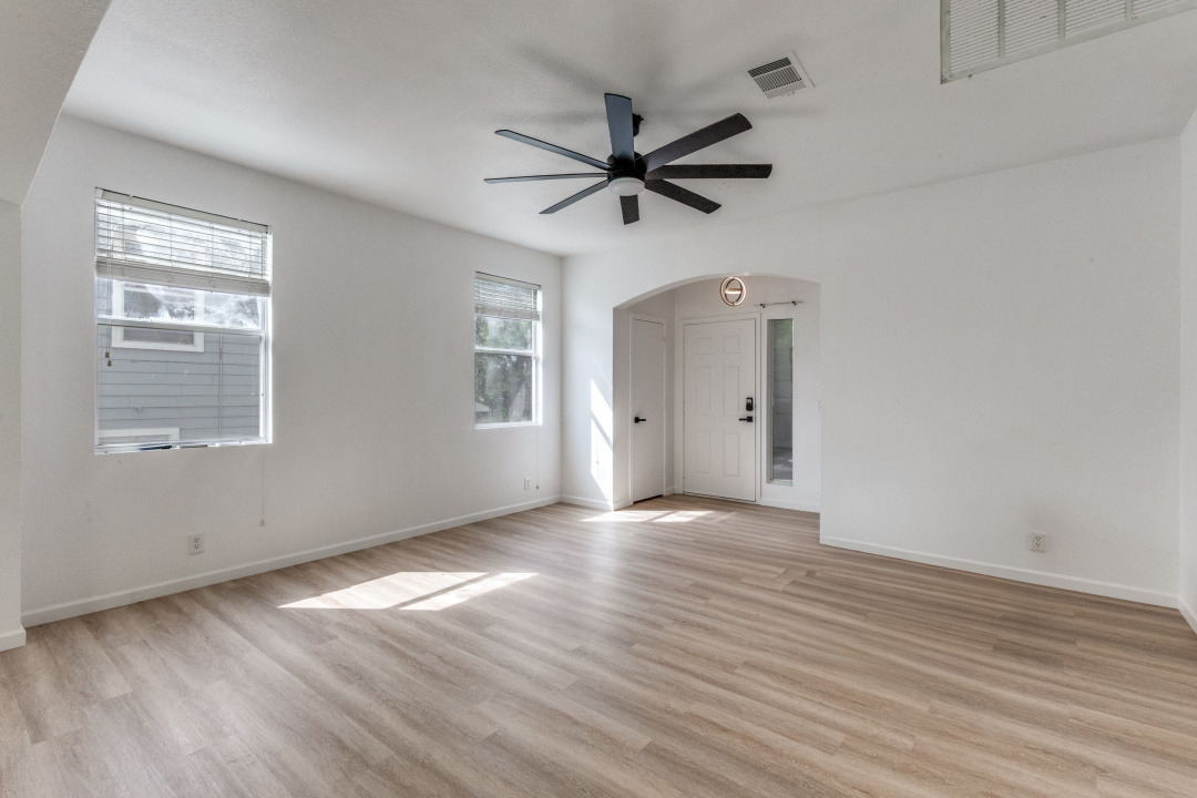 9204 Magna Carta Loop Austin, TX 78754 - Photo 4 of 27 Spare room featuring arched walkways, light wood-type flooring, and ceiling fan