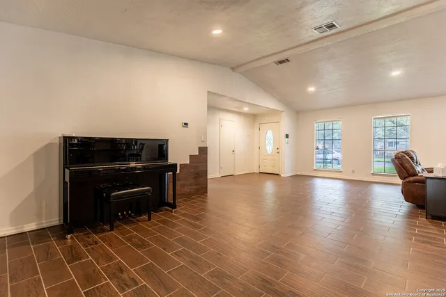 a view of a livingroom with furniture and an empty room