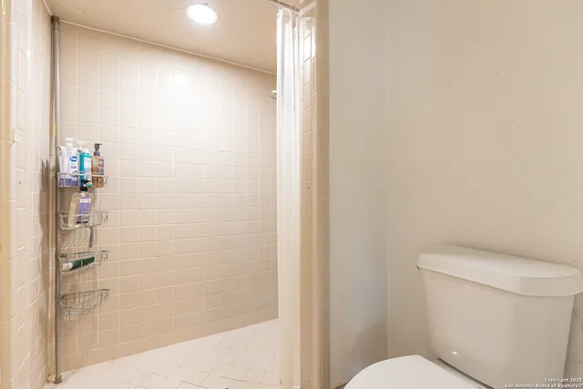 a white toilet sitting next to a bathroom sink