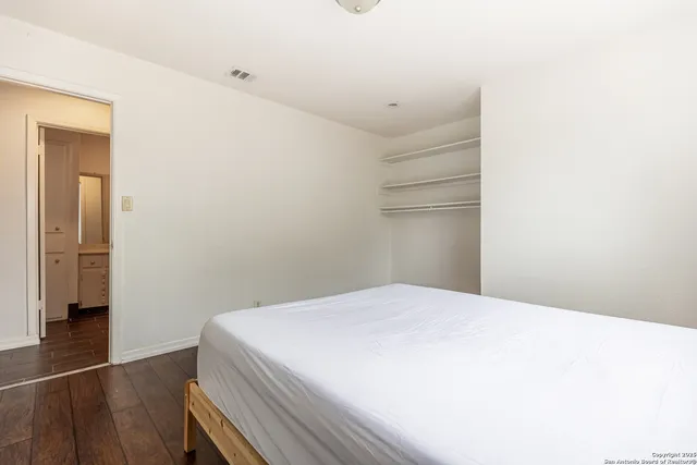 a bedroom with a bed and a mirror