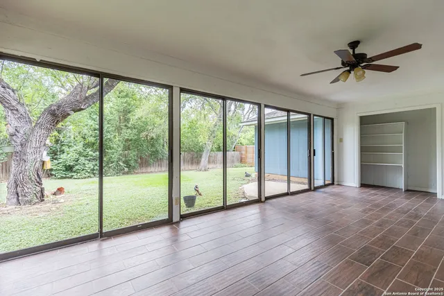 a view of a room with wooden floor and windows