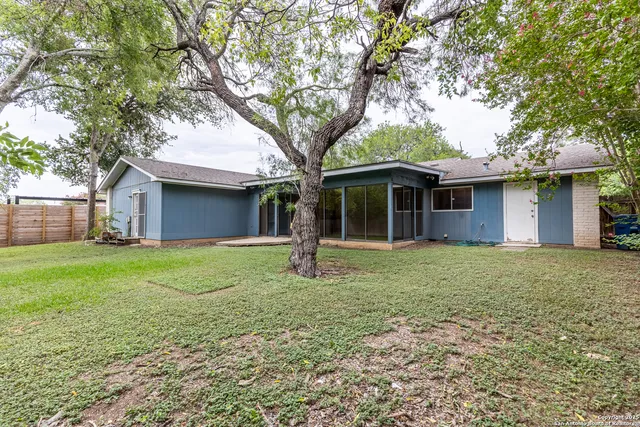 a front view of a house with a garden and yard