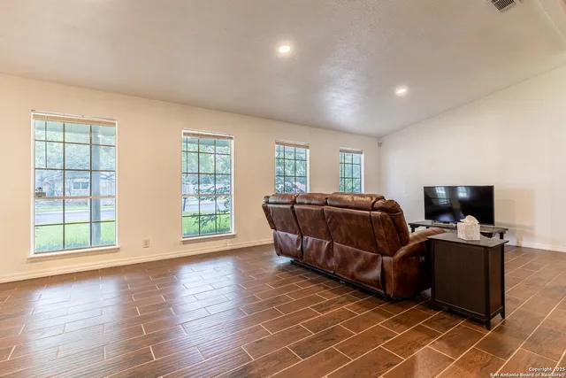 a living room with couch and a flat screen tv