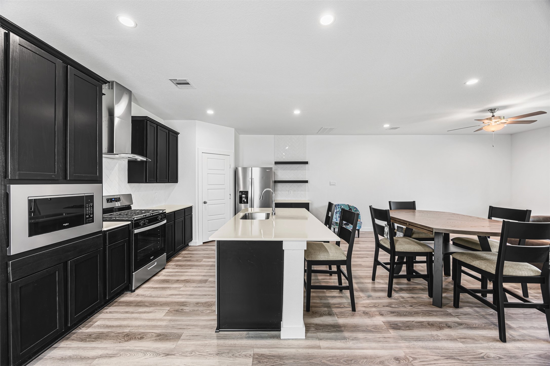 12305 Brandenburg Gate Road Houston, TX 77047 - Photo 5 of 22 a large kitchen with stainless steel appliances kitchen island granite countertop a large counter top space and stainless steel appliances