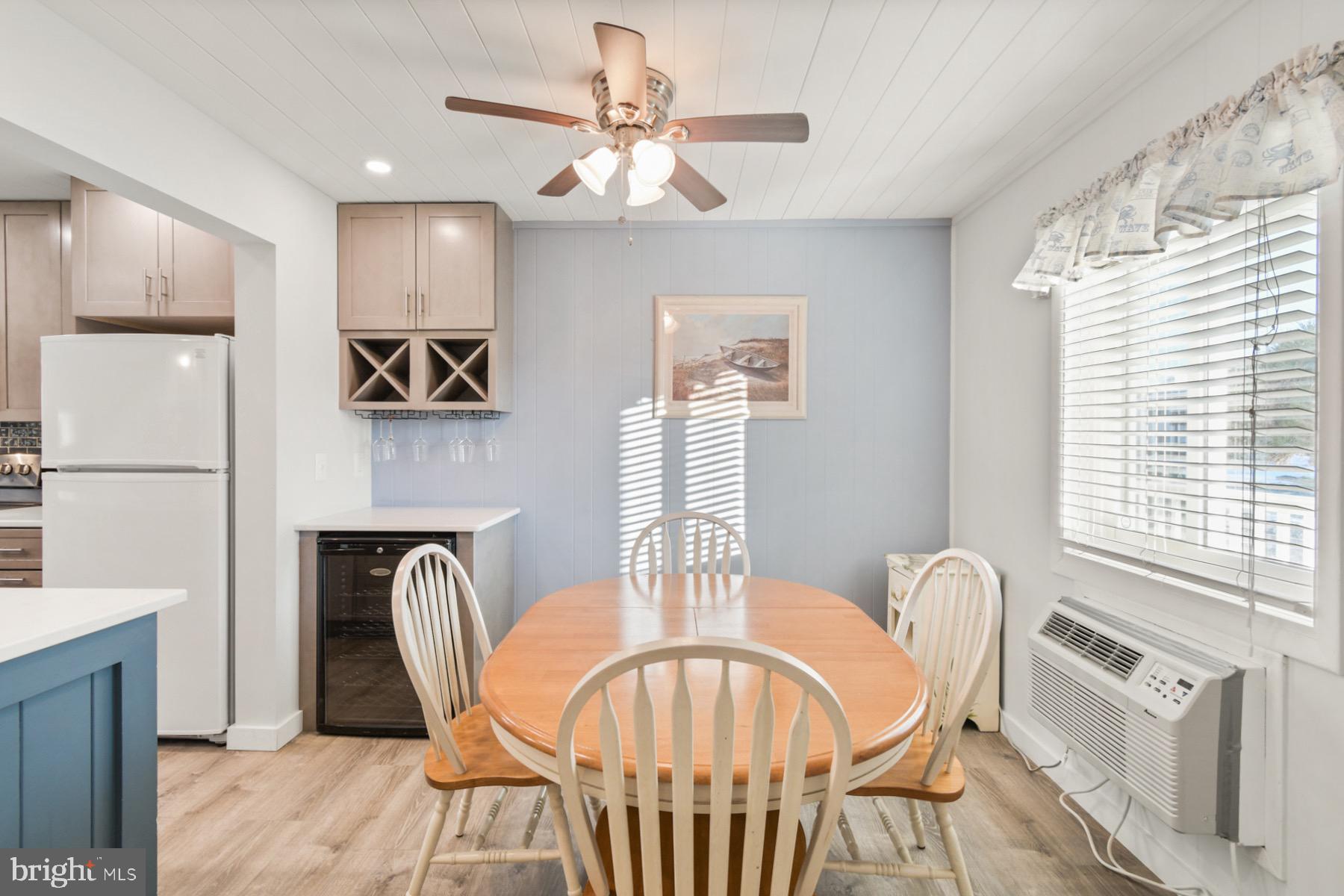 722 Mooring Road, Unit A104 Ocean City, MD 21842 - Photo 4 of 33 a view of a a dining room with furniture window and wooden floor