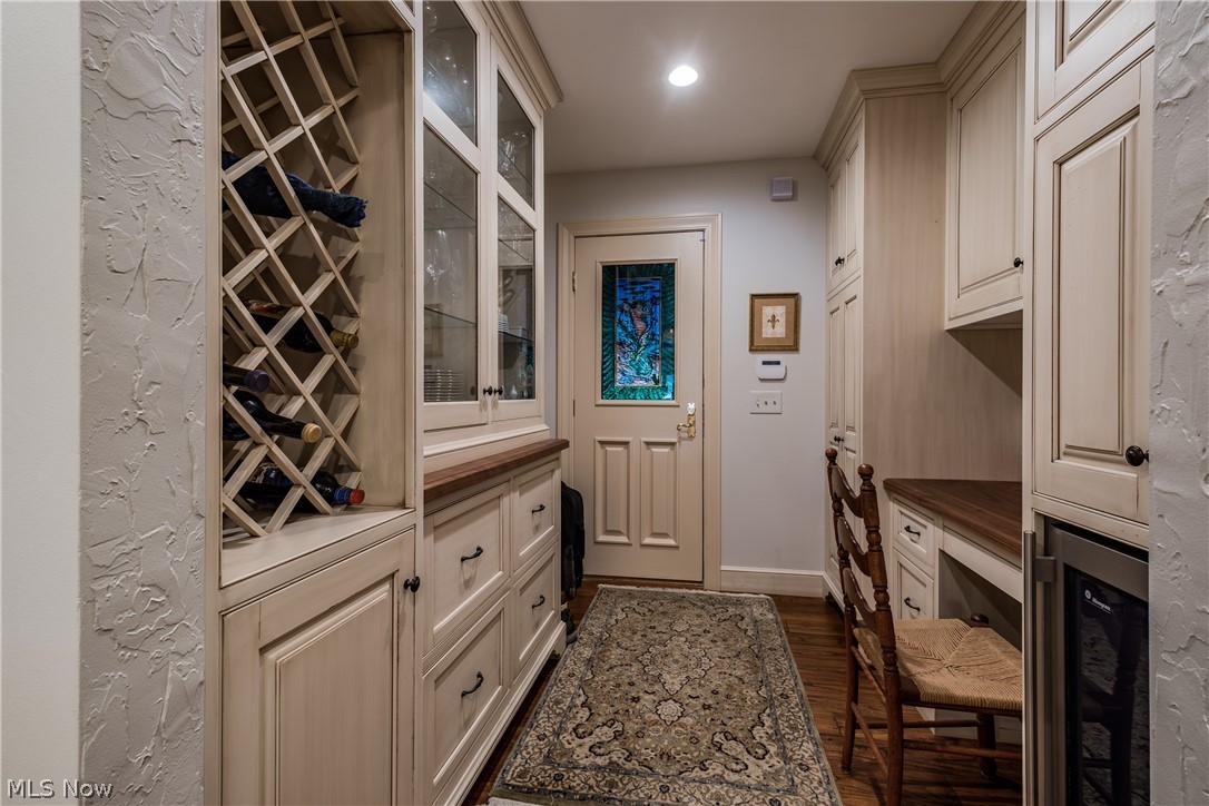 1415 Harbor Drive Northwest Canton, OH 44708 - Photo 24 of 46 Back Hallway/Mud Room with dark wood-type flooring, built in desk, wine rack, china cabinet and beverage cooler