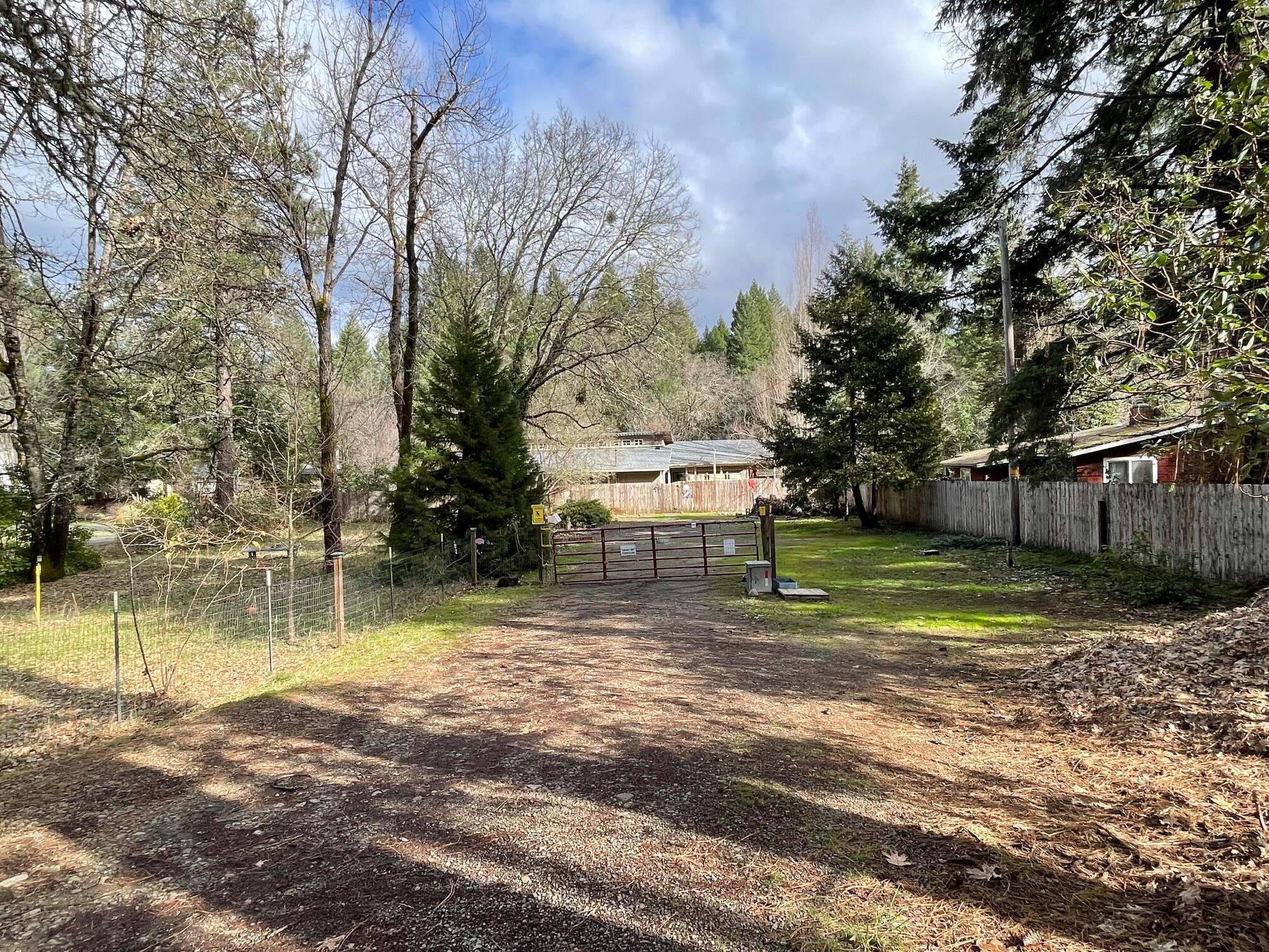 411 South Old Stage Road Cave Junction, OR 97523 - Photo 2 of 39 a view of a backyard with green space