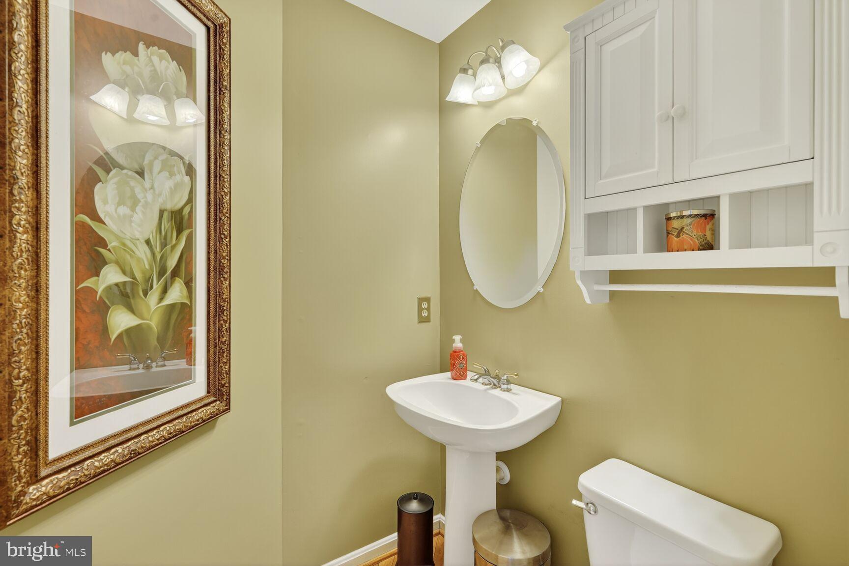 8205 Swamp Rose Place Laurel, MD 20724 - Photo 12 of 34 a bathroom with a toilet sink and mirror