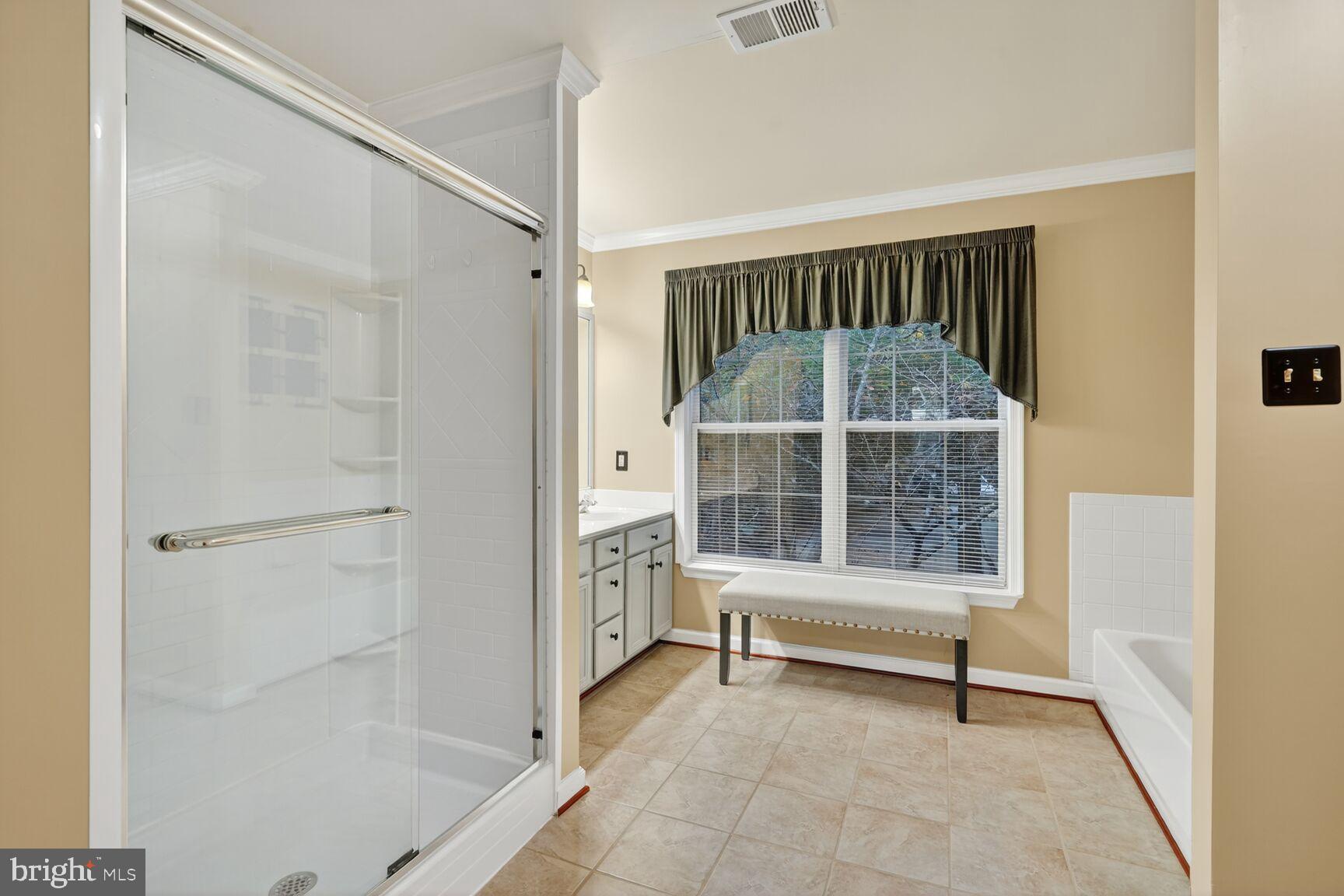 8205 Swamp Rose Place Laurel, MD 20724 - Photo 15 of 34 a bedroom with a window and a glass door shower