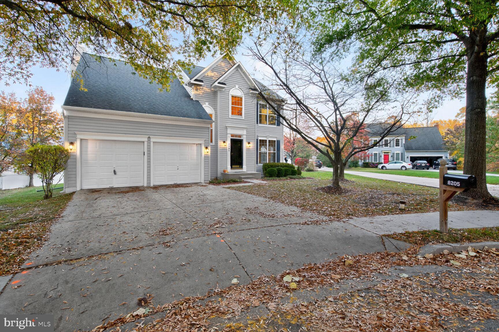 8205 Swamp Rose Place Laurel, MD 20724 - Photo 2 of 34 a view of a white house with a large tree