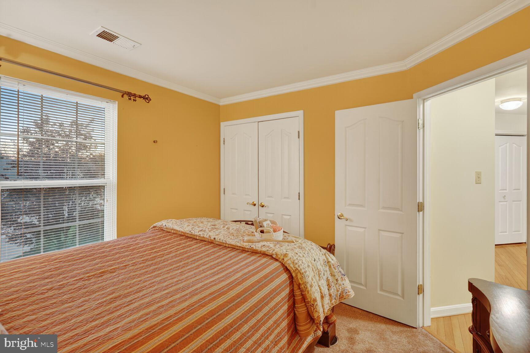 8205 Swamp Rose Place Laurel, MD 20724 - Photo 21 of 34 a bedroom with a bed and a window