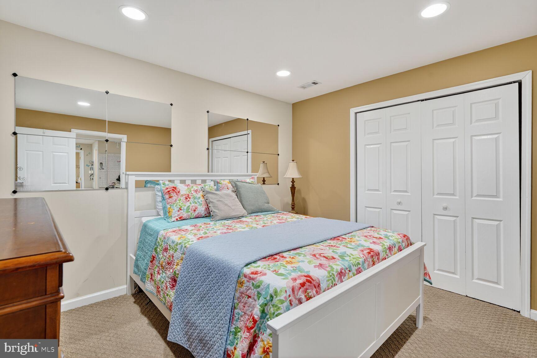 8205 Swamp Rose Place Laurel, MD 20724 - Photo 27 of 34 a bedroom with a bed and a dresser in it