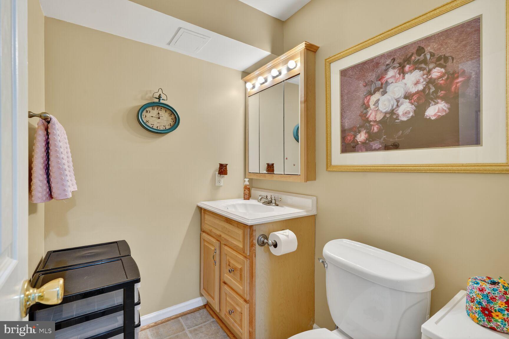 8205 Swamp Rose Place Laurel, MD 20724 - Photo 29 of 34 a bathroom with a toilet and a sink