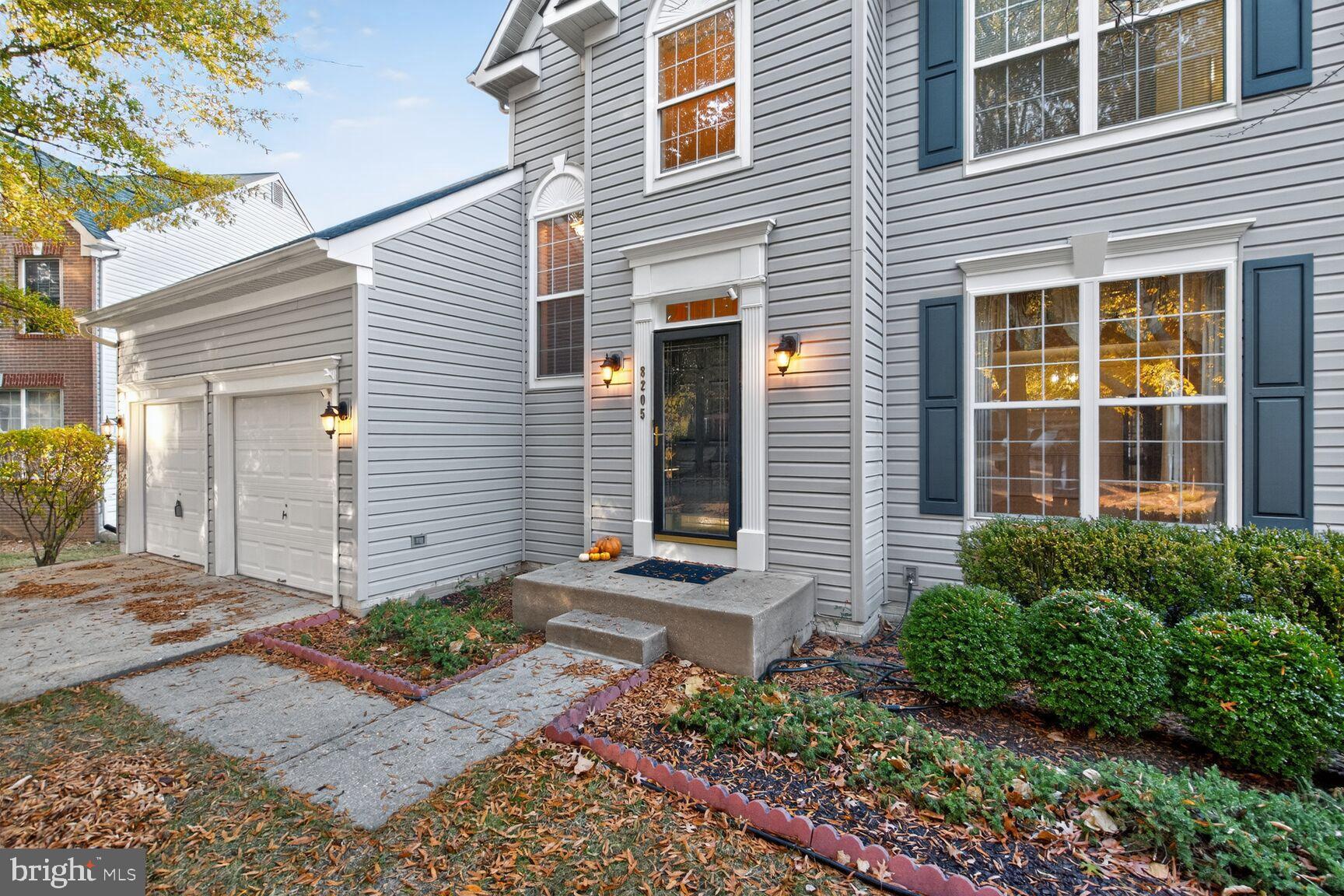 8205 Swamp Rose Place Laurel, MD 20724 - Photo 3 of 34 a front view of a house with garden