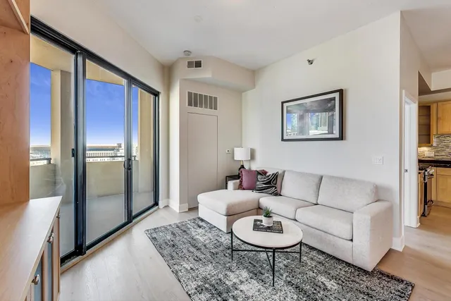 a living room with furniture and a painting on the wall