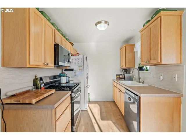 a kitchen that has a sink and a stove