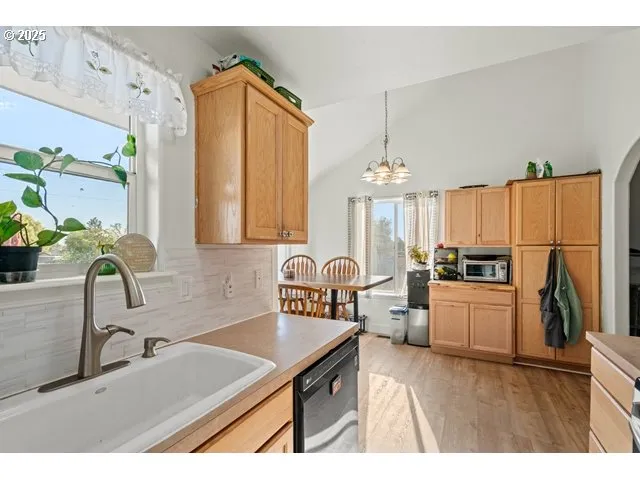 a kitchen with sink refrigerator and microwave