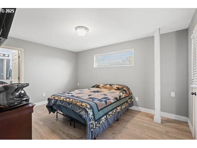 a bed sitting in a bedroom next to a window