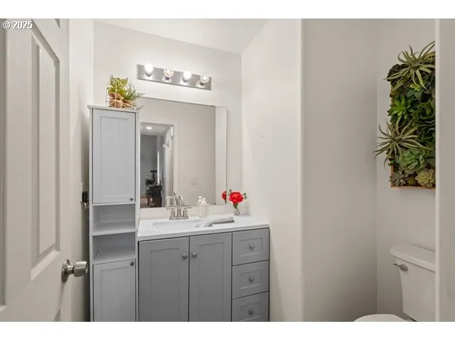 a bathroom with a sink vanity and a mirror