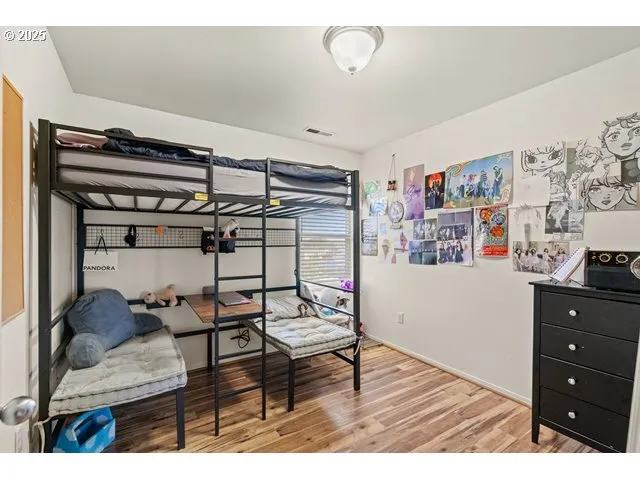 a bedroom with furniture and wooden floor