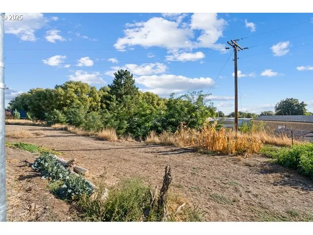 a view of a white house with a yard