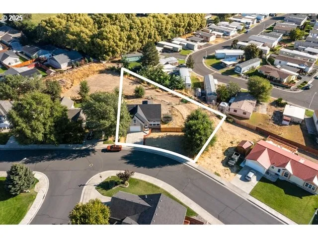 an aerial view of residential houses with outdoor space