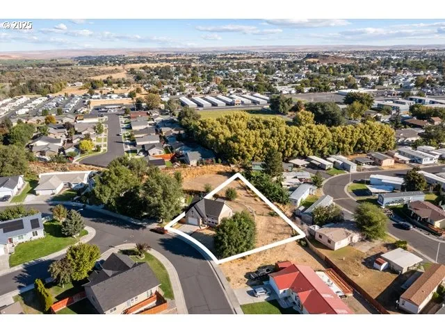 an aerial view of residential houses with outdoor space