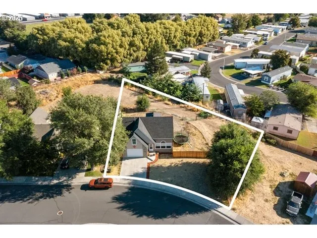 an aerial view of residential houses with city view
