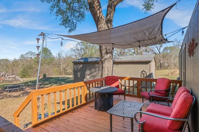 a view of a yard with trees in front of it