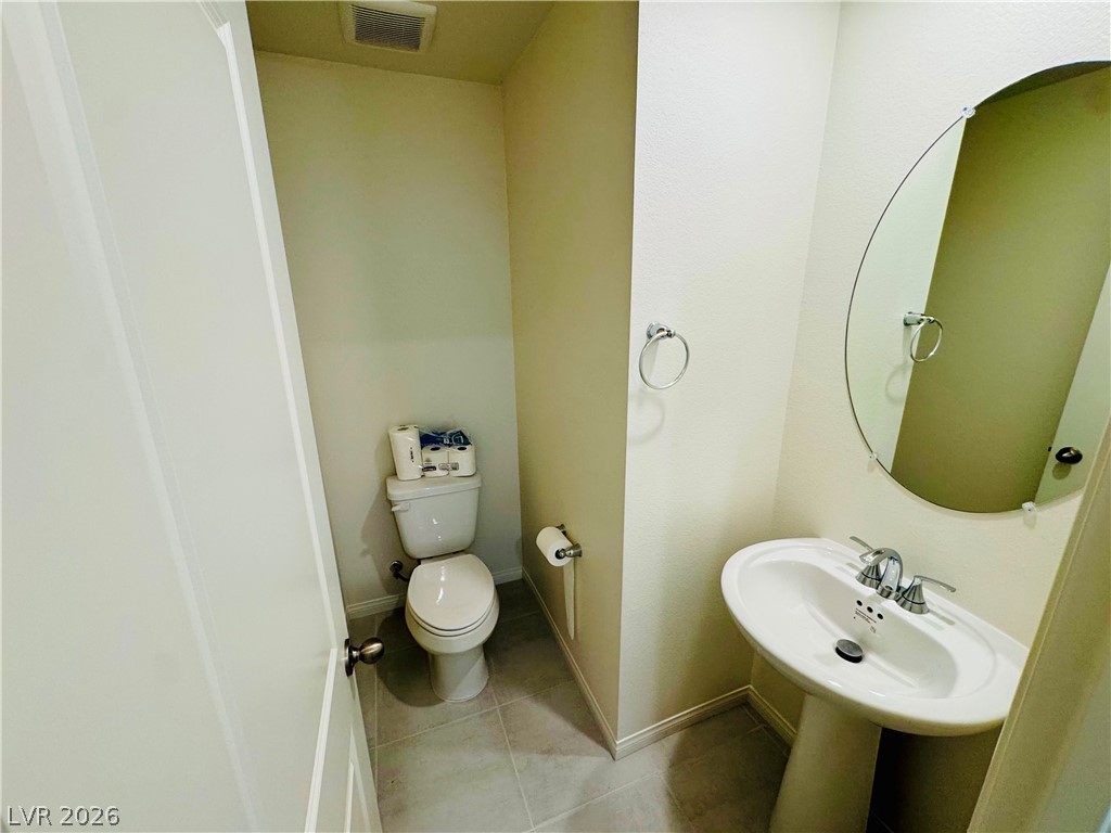 9249 Innot Avenue Las Vegas, NV 89148 - Photo 7 of 24 A compact and functional bathroom space featuring a clean pedestal sink and modern fixtures.