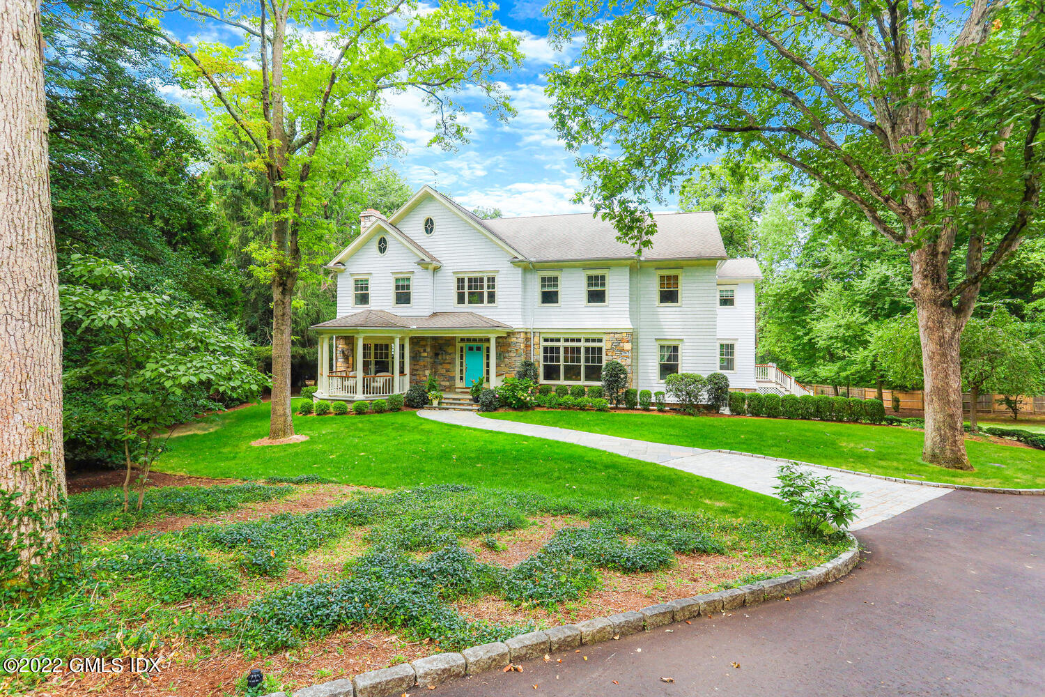 a front view of a house with a yard table and chairs