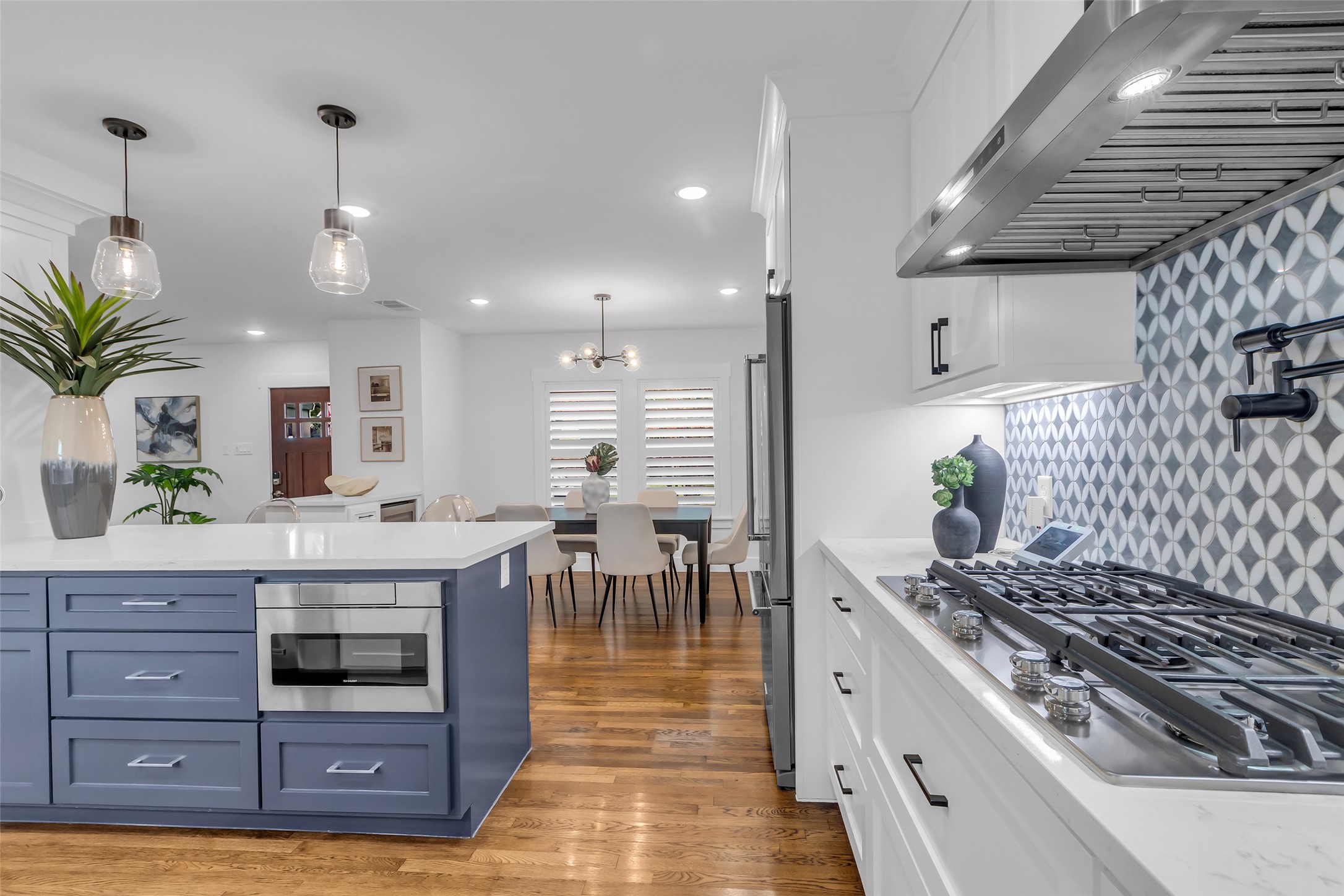 2611 Ruth Street Houston, TX 77004 - Photo 13 of 50 A closer look highlights the high-quality appliances in the kitchen, with the dining area visible in the background. Don't forget the pot filler!