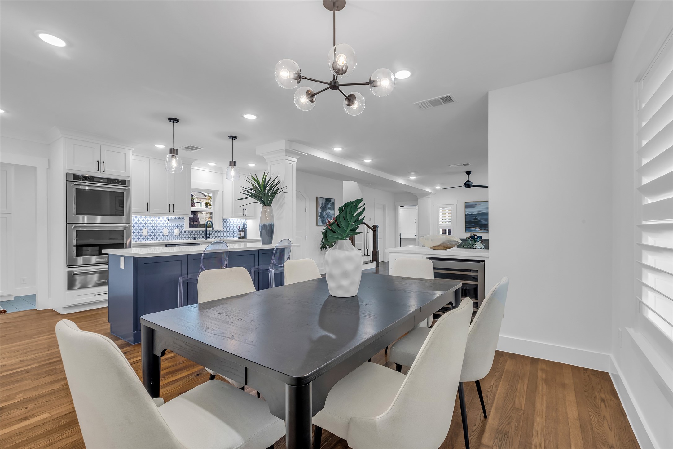 2611 Ruth Street Houston, TX 77004 - Photo 22 of 50 From the corner of the dining room, this view looks toward the kitchen, with a partial view of the living room beyond, highlighting the open flow between the spaces.