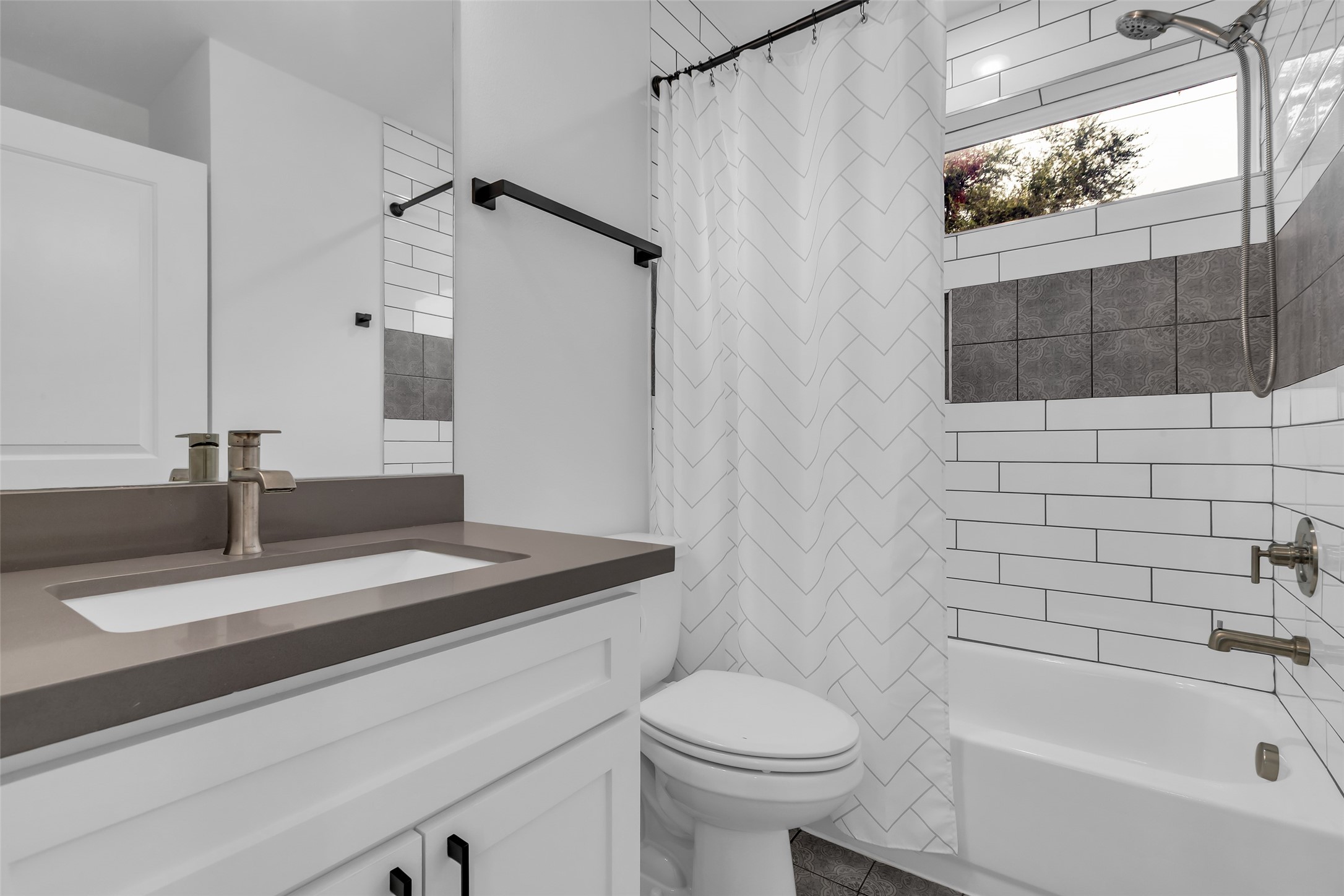 2611 Ruth Street Houston, TX 77004 - Photo 26 of 50 The first-floor bathroom features a tub and shower combination, providing practical options for daily use. The bathroom includes access doors to the attached bedroom and to the living room.