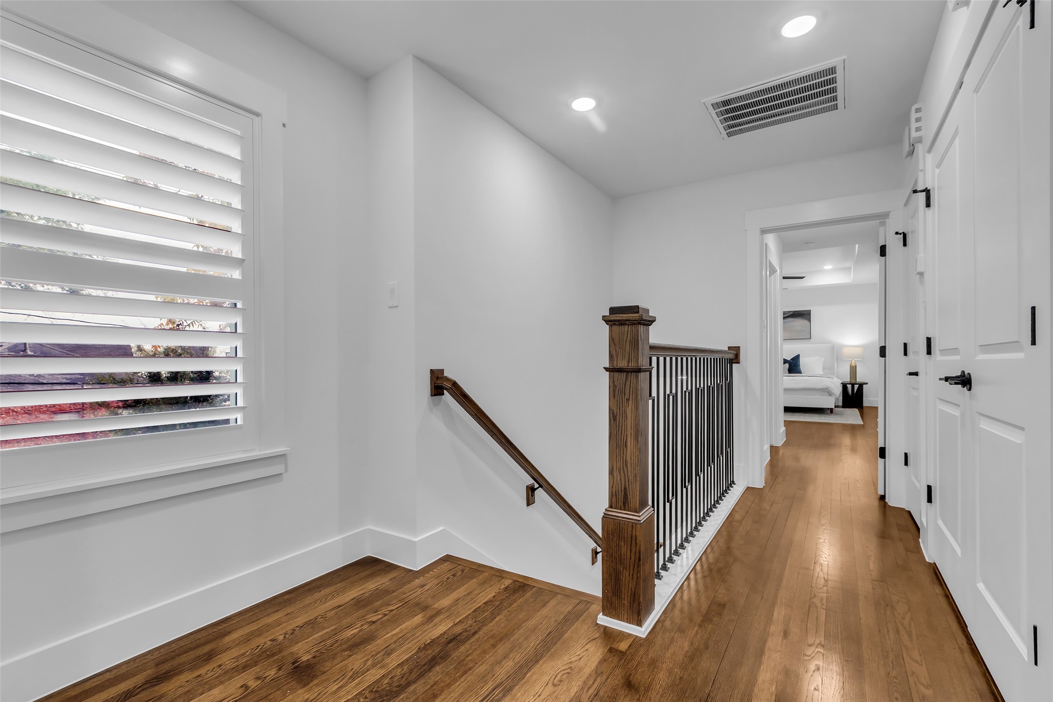 2611 Ruth Street Houston, TX 77004 - Photo 28 of 50 Heading to the second floor, the stairs lead to a hallway that connects to both private bedrooms and shared spaces.