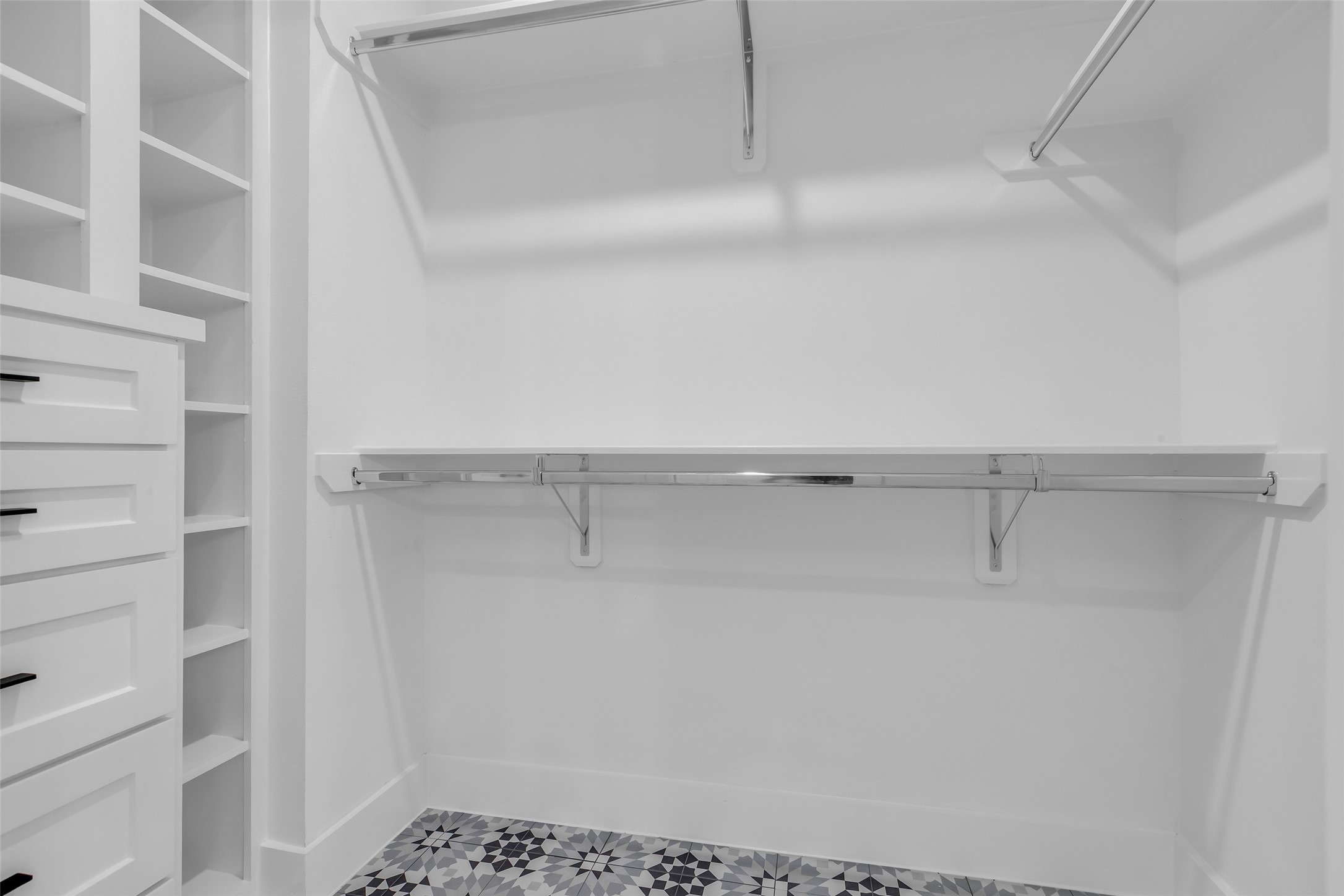 2611 Ruth Street Houston, TX 77004 - Photo 33 of 50 The primary bedroom includes 2 walk-in closets with built-in shelves and racks, providing organized storage for clothing and accessories. This closet is accessed from the bathroom.