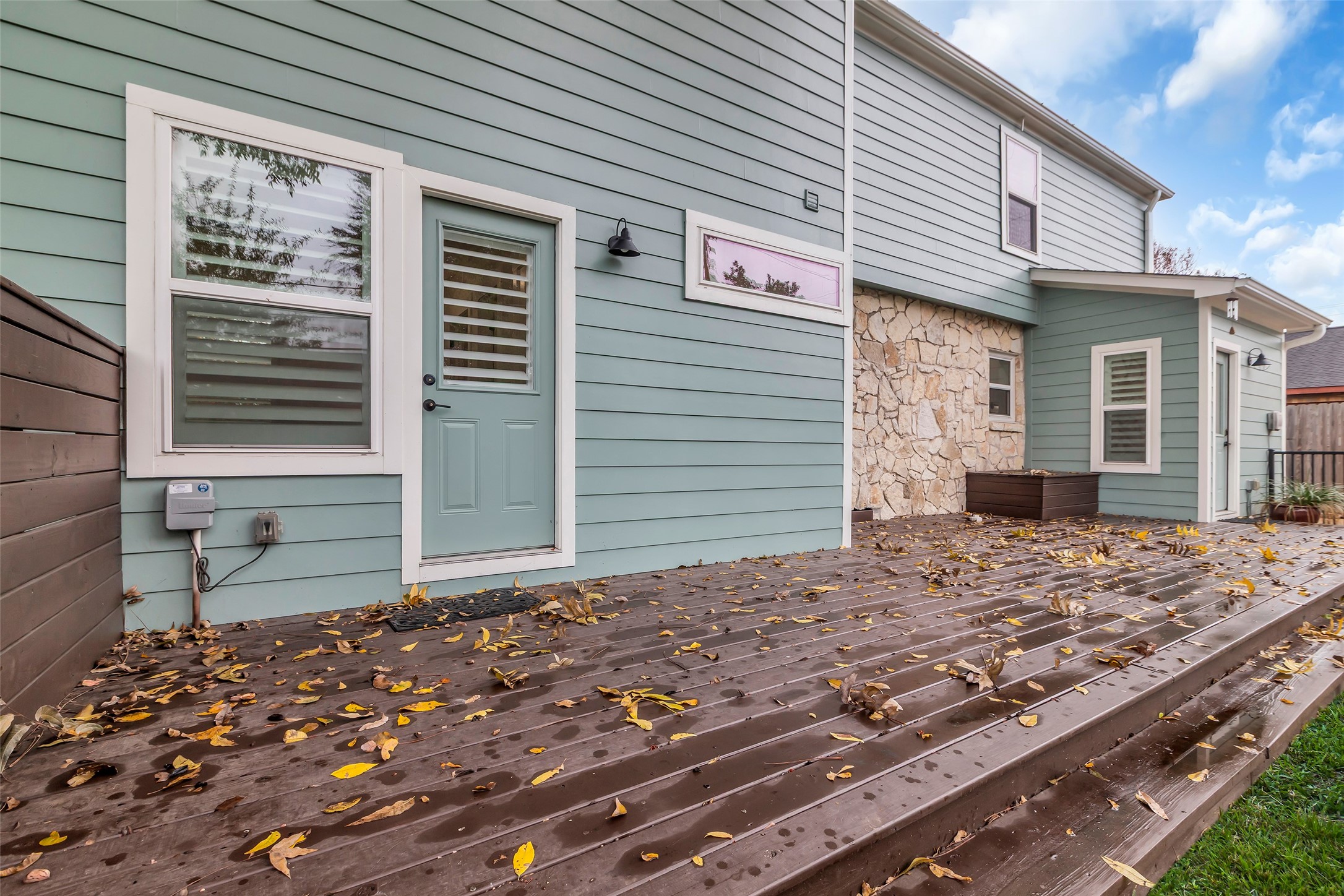 2611 Ruth Street Houston, TX 77004 - Photo 41 of 50 A closer view of the spacious wooden deck shows both back entrances to the first-floor bedroom, adding easy access between indoor and outdoor spaces.